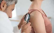 Dermatologist examining a patient