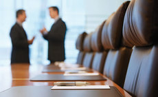 Businessmen having a conversation in a boardroom