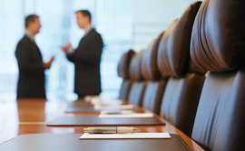 Businessmen having a conversation in a boardroom Businessmen having a conversation in a boardroom