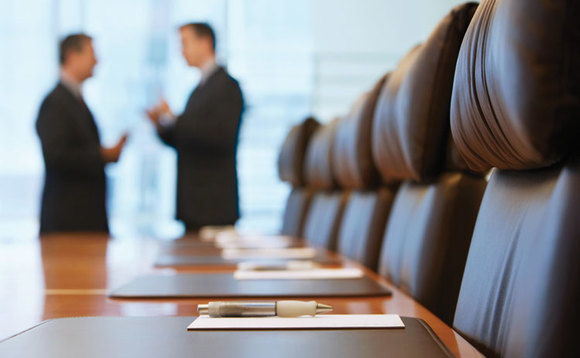 Businessmen having a conversation in a boardroom