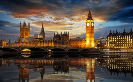 The Palace of Westminster and the Big Ben clock tower by the Thames river in London The Palace of Westminster and the Big Ben clock tower by the Thames river in London