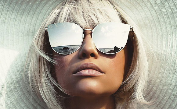 Woman wearing stylish sunglasses and hat