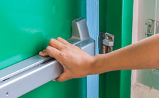 Man pushing fire door