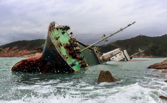 Sinking ship on rocky coastline Sinking ship on rocky coastline