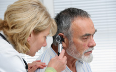 Doctor performing hearing exam