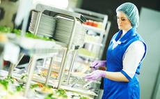 Woman serving food in cafeteria