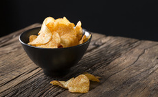 Crisps in a bowl on a wooden table