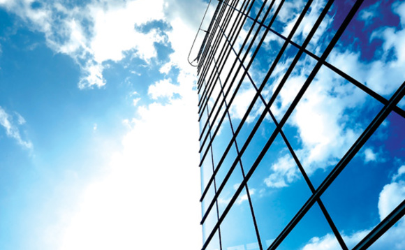 An office building with a cloudy sky in the background An office building with a cloudy sky in the background