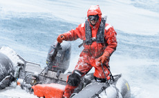 Man in waterproof suit on inflatable boat