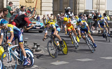 Cyclists competing in the Tour de France turn a corner